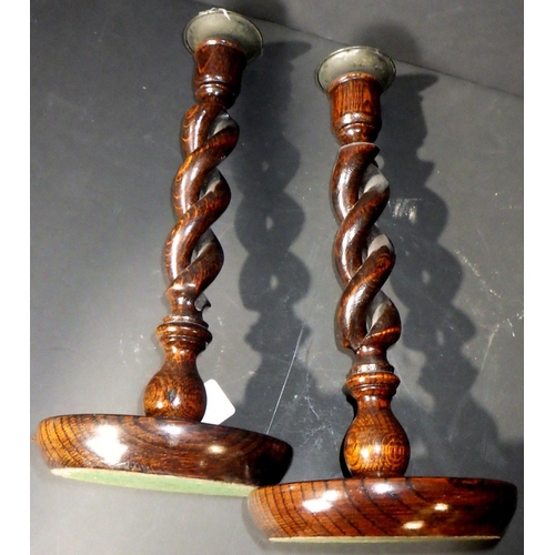 116 - A pr of twisted candlesticks 30cm tall