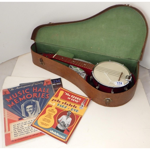 174 - A George Formby Dallas Uke Banjo with accessories together with a framed Palladium poster and epheme... 