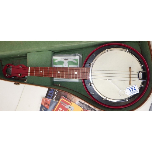 174 - A George Formby Dallas Uke Banjo with accessories together with a framed Palladium poster and epheme... 