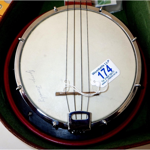 174 - A George Formby Dallas Uke Banjo with accessories together with a framed Palladium poster and epheme... 