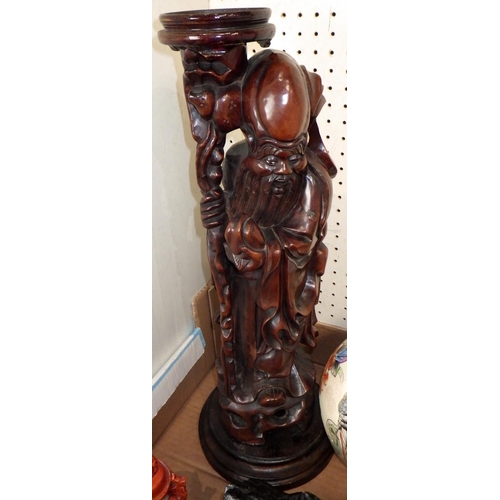 196 - A carved Oriental stand together with two ginger jars and a clock