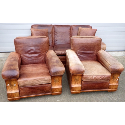 531 - A brown leather upholstered walnut faced three piece suite, settee 190cm wide, springs a/f, leather ... 