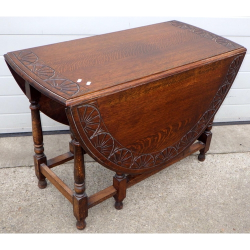 541 - An oak gateleg table with carved border, 110cm long