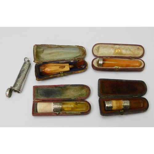 94 - A silver cheroot holder case, Birmingham 1913; four cheroot holders, including three silver mounted ... 