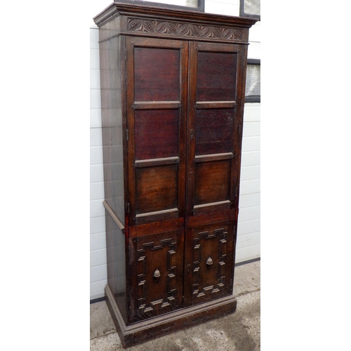 558 - A panelled oak hall wardrobe, 191cm tall, 82cm wide, 52cm deep