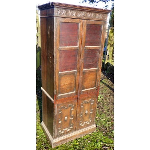 558 - A panelled oak hall wardrobe, 191cm tall, 82cm wide, 52cm deep