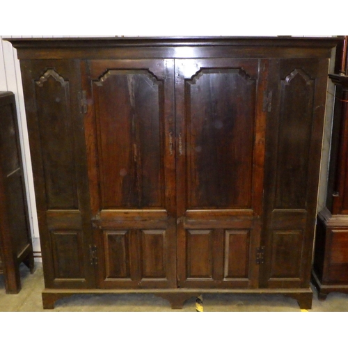 559 - A panelled oak wardrobe, 194cm wide, 180cm tall