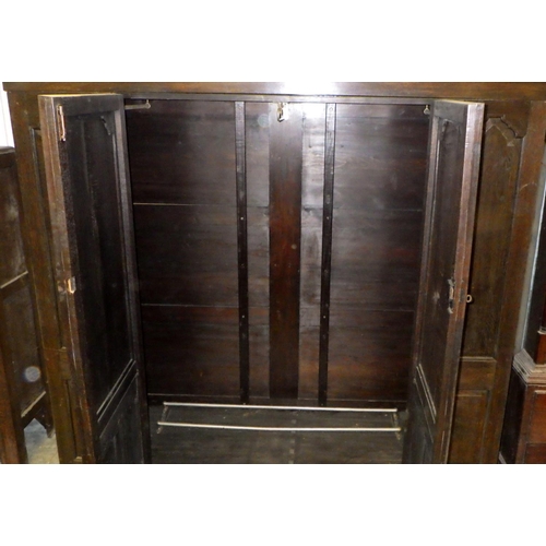 559 - A panelled oak wardrobe, 194cm wide, 180cm tall