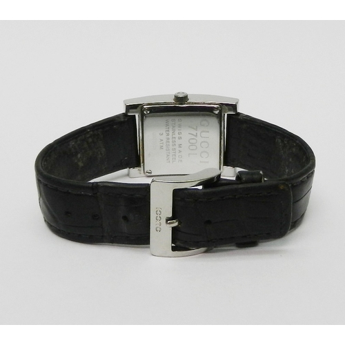 2 - A Gucci 7700L wristwatch comprising a quartz movement in a rectangular steel case on a Gucci leather... 