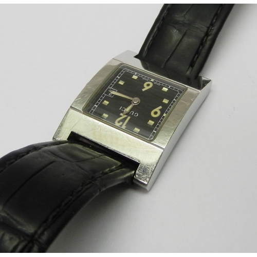 2 - A Gucci 7700L wristwatch comprising a quartz movement in a rectangular steel case on a Gucci leather... 