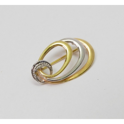 32 - A brooch of 1980s oval ring design by Friedrich Speidel, yellow and white metal marked 9kt.  29 x 17... 