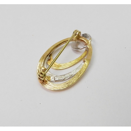 32 - A brooch of 1980s oval ring design by Friedrich Speidel, yellow and white metal marked 9kt.  29 x 17... 