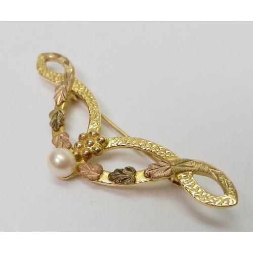 38 - A brooch of swag design, 9ct gold set with a single cultured pearl.  42mm across / 2.5g gross