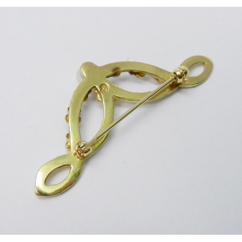 38 - A brooch of swag design, 9ct gold set with a single cultured pearl.  42mm across / 2.5g gross