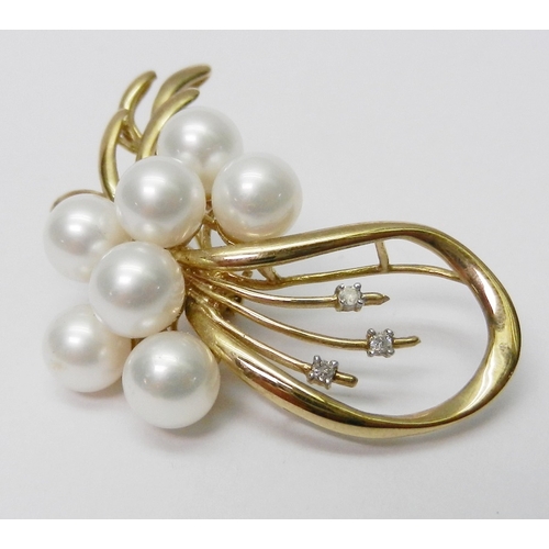 39 - A brooch of spray design, yellow metal marked 9K set with three round cut diamonds and seven pearls.... 