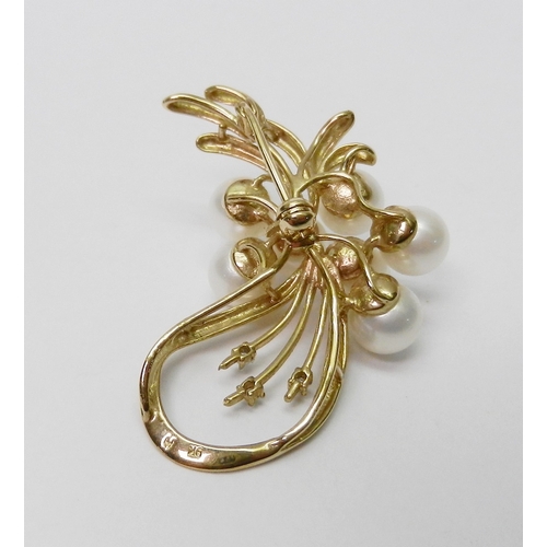 39 - A brooch of spray design, yellow metal marked 9K set with three round cut diamonds and seven pearls.... 