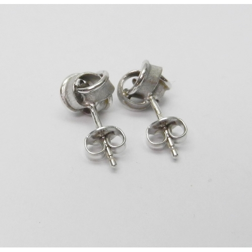 40 - A pair of ribbon knot design stud earrings, 18ct white gold.  Heads 7mm diameter / 1.5g