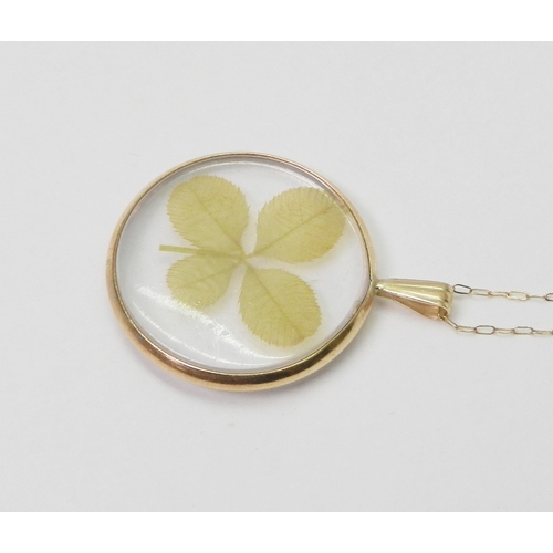 42 - A four leaf clover pendant, yellow metal framed, the whole suspended on a fine chain link necklace