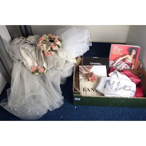 372 - A wedding dress, red leather jacket, fashion books etc