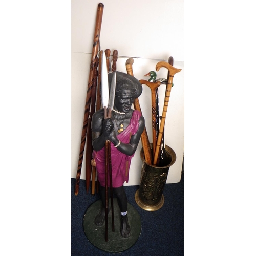 382 - A 95cm tall Masai Warrior figure together with carved walking sticks and stick stand (qty)