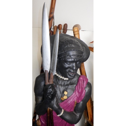 382 - A 95cm tall Masai Warrior figure together with carved walking sticks and stick stand (qty)