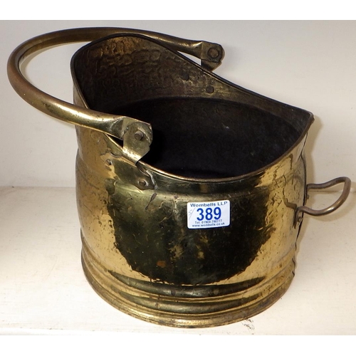 389 - Four cobbler's cast iron lasts together with a brass coal bucket