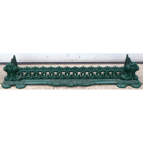 452 - A green painted cast iron fender, 136cm wide