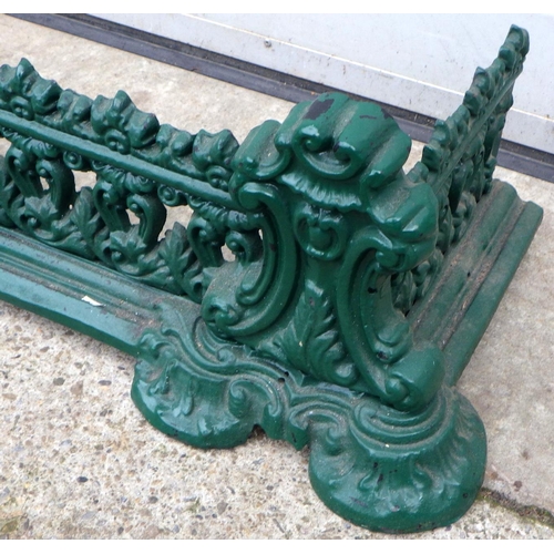 452 - A green painted cast iron fender, 136cm wide