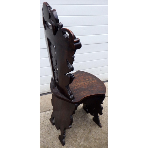 455 - A figural carved hall chair, crest repaired