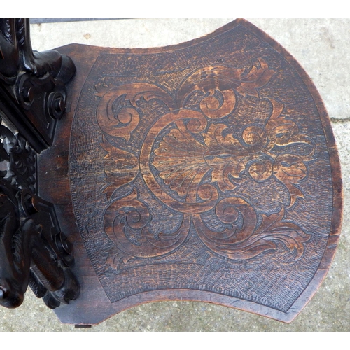 455 - A figural carved hall chair, crest repaired