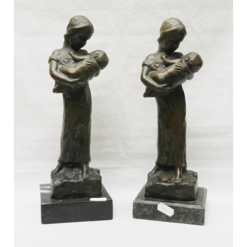 124 - Two matching figurines depicting a female figure holding a child, bronze on stone base, modern.  Eac... 