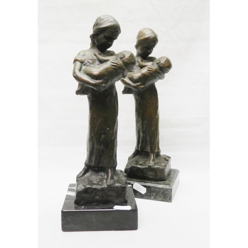 124 - Two matching figurines depicting a female figure holding a child, bronze on stone base, modern.  Eac... 