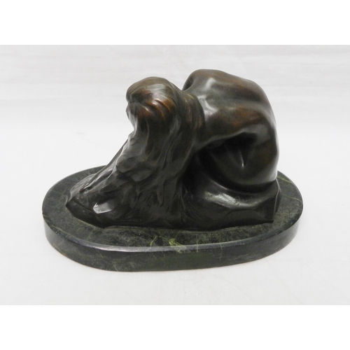 138 - A figurine depicting a seated female nude, bronze on a stone base, modern.  Base 265mm long.