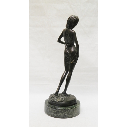 139 - A figurine depicting a partially clothed woman, bronze on a stone base, modern. 315mm tall