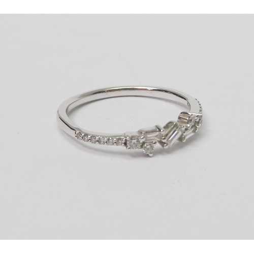 74 - A 9ct white gold and diamond half-hoop ring comprising a central setting of three baguette cut stone... 