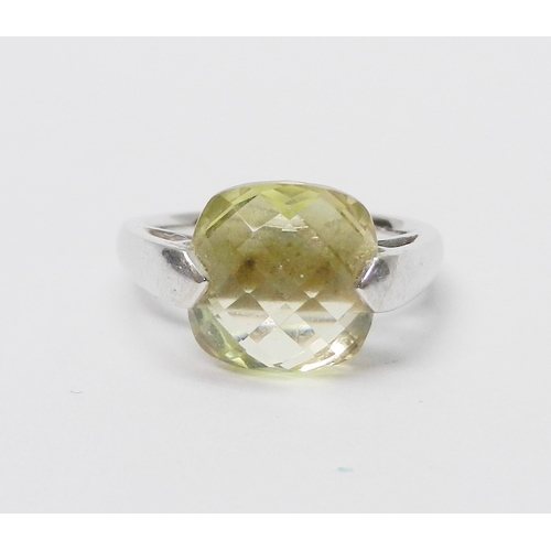 76 - A modern Art Jewellery single stone statement ring, 9ct white gold set with a cushion shaped green c... 