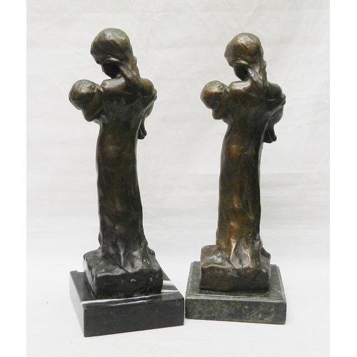 124 - Two matching figurines depicting a female figure holding a child, bronze on stone base, modern.  Eac... 