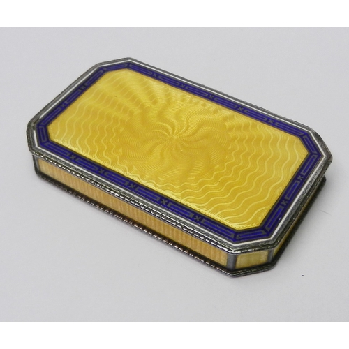 27 - An Austrian snuff box having a sprung hinge lid, white metal marked 900 and enamel on engine-turned ... 