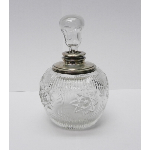 29 - A cut glass scent bottle having a silver collar, London 1912.  135mm tall incl stopper.