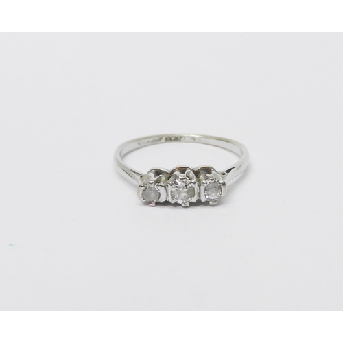 66 - A three stone diamond ring marked 18ct & Plat.