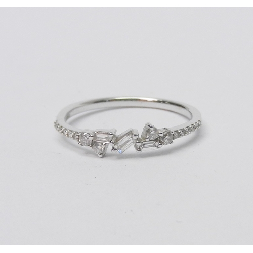 74 - A 9ct white gold and diamond half-hoop ring comprising a central setting of three baguette cut stone... 