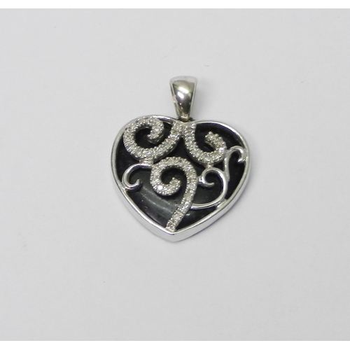 75 - A heart-shaped pendant, 9ct white gold set with diamonds over an onyx core.  3g gross / 23mm long in... 