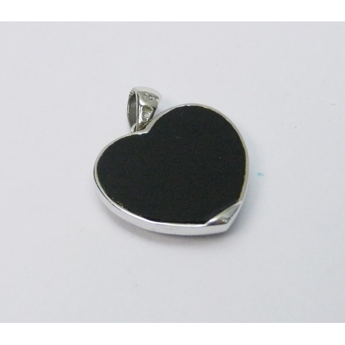 75 - A heart-shaped pendant, 9ct white gold set with diamonds over an onyx core.  3g gross / 23mm long in... 