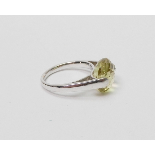 76 - A modern Art Jewellery single stone statement ring, 9ct white gold set with a cushion shaped green c... 