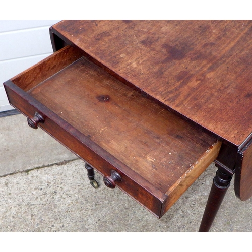 577 - A Regency mahogany Pembroke table on turned legs, chip in rule joint