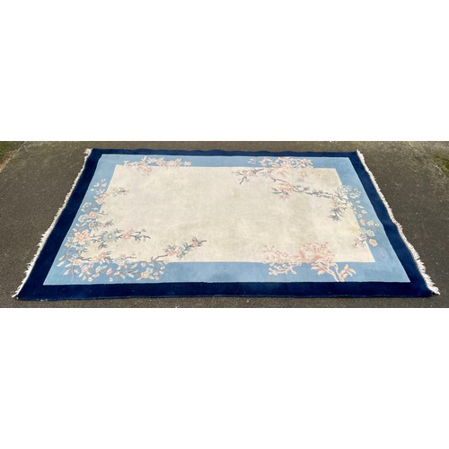 574 - A cream / blue ground Chinese rug, marks (a/f)