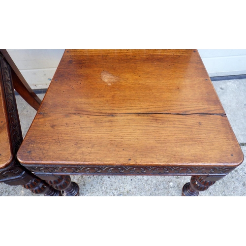 512 - A pair of carved panelled oak hall chairs