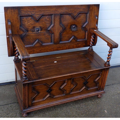 A 1930's barleytwist panelled oak monks bench, 106cm wide