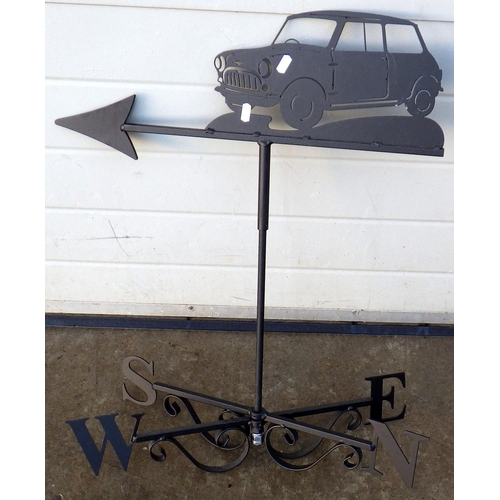 564 - A metal weather vane, surmounted by a Mini car, 68cm tall