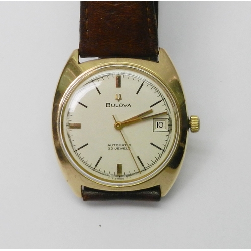 A Bulova automatic wristwatch comprising a 23 jewel movement in a 9ct gold cushion case, c1970.  35mm across case / 38mm lug to lug.  A/F screw-on case back bruised, calendar complication non-functioning, stem distorted.